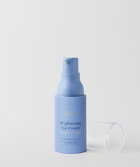 Brightening Eye Cream - Blue pump bottle with clear cap off and laying on it's side next to the bottle